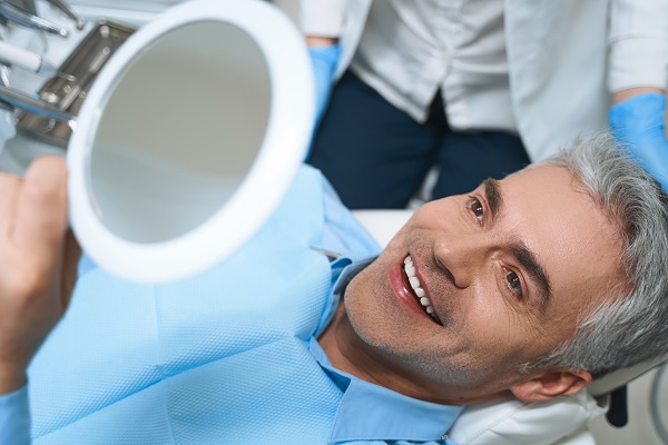 Joyful,Male,Is,Lying,In,Chair,And,Looking,Into,Mirror